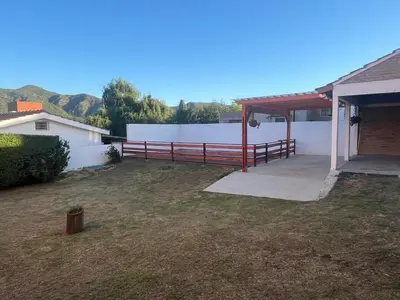 a backyard with a fence and a white wall at La soñada San Antonio de Arredondo in San Antonio de Arredondo