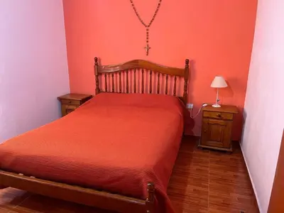 a bedroom with a bed and a table with a lamp at La soñada San Antonio de Arredondo in San Antonio de Arredondo