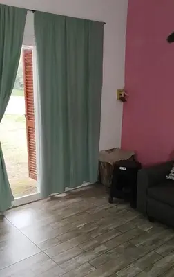 a living room with a couch and a window at Cabaña rio de los sauces in Río de los Sauces