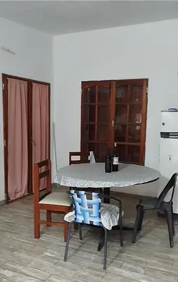 a table and chairs in a room with a table and chairs at Cabaña rio de los sauces in Río de los Sauces
