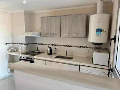 a white kitchen with a sink and a stove at 2point in Río Tercero