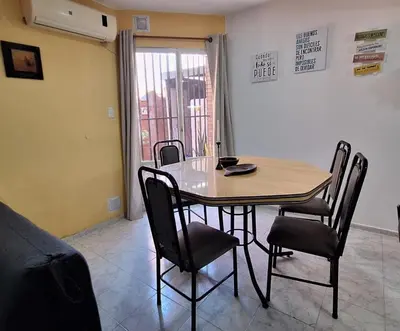 a dining room table and chairs in a room at La Gringa House in Cordoba