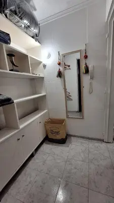 a room with white shelves and a mirror in it at La Gringa House in Cordoba