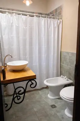 a bathroom with a sink and a toilet at El Bosque de Simba - Cabaña in La Estancia