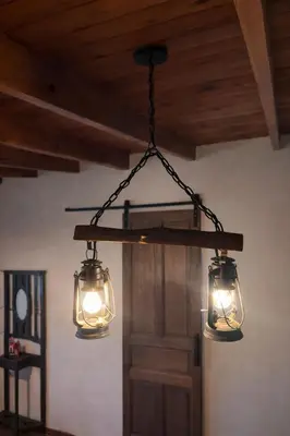 a couple of lights hanging from a ceiling at El Bosque de Simba - Cabaña in La Estancia