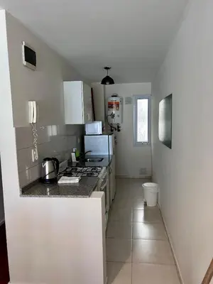 a kitchen with a stove and a counter top at Departamento amplio 3 personas Zona Nueva Córdoba in Cordoba