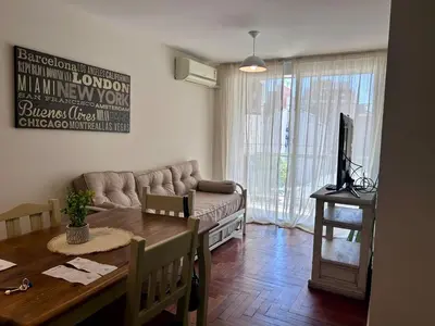 a living room with a couch and a dining room table at Departamento amplio 3 personas Zona Nueva Córdoba in Cordoba