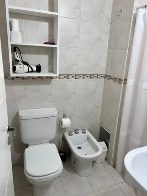 a small bathroom with a toilet and a sink at Departamento amplio 3 personas Zona Nueva Córdoba in Cordoba
