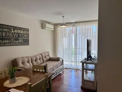 a living room with a couch and a table at Departamento amplio 3 personas Zona Nueva Córdoba in Cordoba