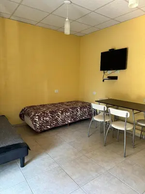 a room with a bed and a table and chairs at Complejo Udacha - APART in Carpintería
