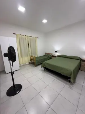 a bedroom with a bed and a fan in a room at Departamentos Mi Cielo in Villa Cura Brochero