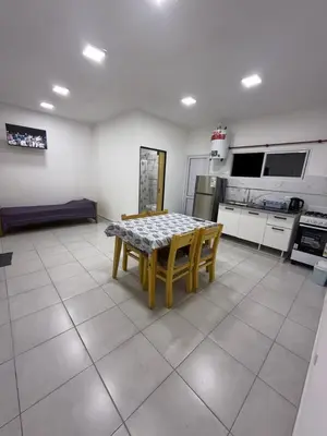 a kitchen with a table and chairs in a room at Departamentos Mi Cielo in Villa Cura Brochero