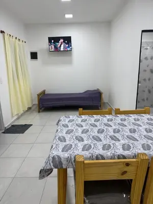 a living room with a table and a couch at Departamentos Mi Cielo in Villa Cura Brochero