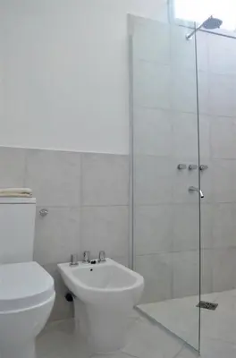 a bathroom with a shower and a toilet and a sink at RM Dpto a pocas cuadras del centro in Villa Carlos Paz