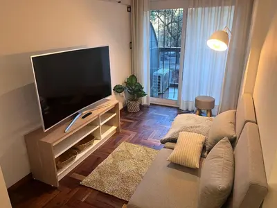 a living room with a large flat screen tv at Departamento para 3 personas Zona Nueva Córdoba in Cordoba