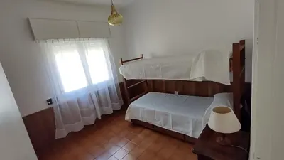 a bedroom with two bunk beds and a window at Casa Jorge Newbery in Villa Carlos Paz