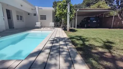 a house with a swimming pool in a yard at Casa Jorge Newbery in Villa Carlos Paz