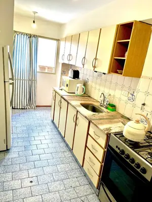 a kitchen with a sink and a microwave at Departamento amplio 4 personas Zona Nueva Córdoba in Cordoba