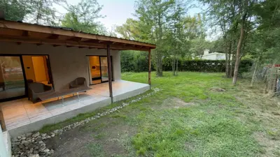 a small house with a bench on a deck at Acasias Vcp New in Villa Ciudad Parque