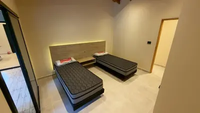 an empty room with two beds in a room at Acasias Vcp New in Villa Ciudad Parque