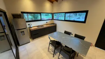a kitchen with a table with chairs and a refrigerator at Acasias Vcp New in Villa Ciudad Parque