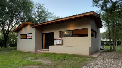 a small house with two signs on the side of it at Acasias Vcp New in Villa Ciudad Parque