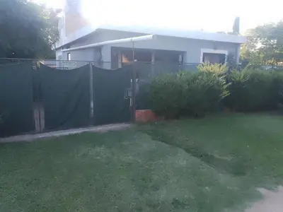 a fence in front of a house with a yard at Latido de Montaña in Bialet Massé