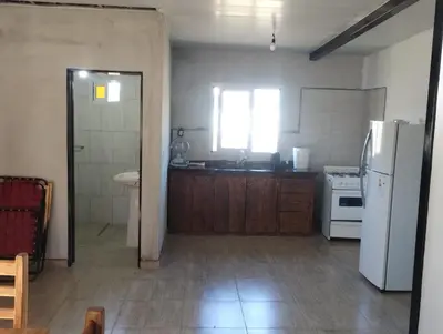 a kitchen with a white refrigerator and a sink at Cabaña gio in Potrero de Garay
