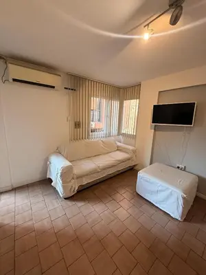 a bedroom with two beds and a flat screen tv at Gral José Artigas B Centro in Cordoba