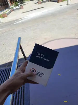 a person holding a book in their hand at Cabañas San Antonio in Santa Rosa de Calamuchita