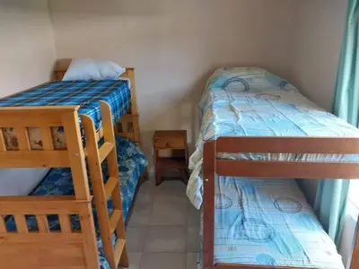 a room with two bunk beds in a room at Cabañas San Antonio in Santa Rosa de Calamuchita