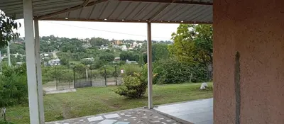 an open porch with a view of a field at La Casita De Mabel in Villa Santa Cruz del Lago