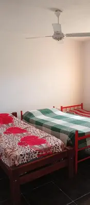 two twin beds in a room with a ceiling at La Casita De Mabel in Villa Santa Cruz del Lago