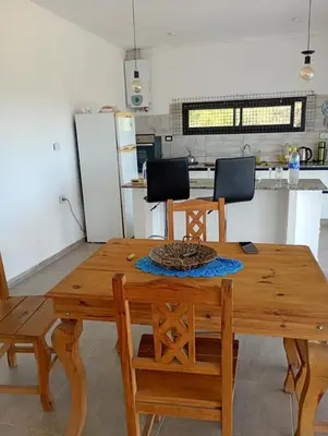 a wooden table and chairs in a kitchen at Casa en sierras de cordoba in San Roque