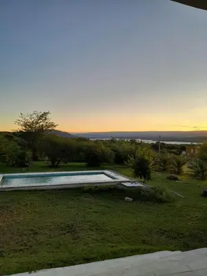 a view of a yard with a swimming pool at Casa en sierras de cordoba in San Roque