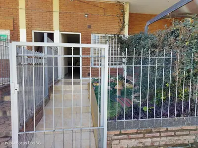 a gate in front of a building with a yard at Marcelina in Villa Carlos Paz