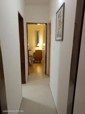 a hallway leading into a hotel room with a mirror at Marcelina in Villa Carlos Paz