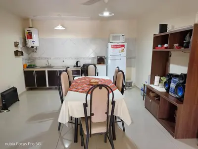 a kitchen with a table and chairs in a room at Marcelina in Villa Carlos Paz