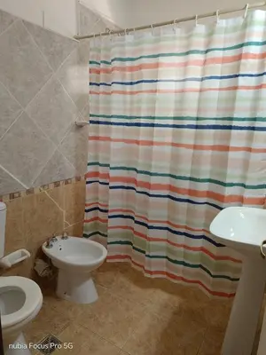 a bathroom with a shower curtain and a sink at Marcelina in Villa Carlos Paz