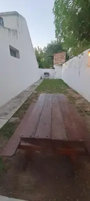 an empty courtyard with a picnic table in a building at Complejo La Paz in Villa Carlos Paz
