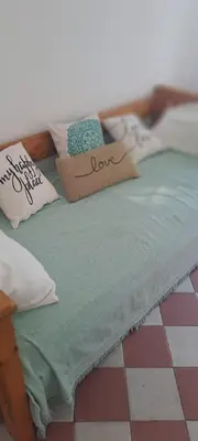 a bed with two pillows and a sign on it at Complejo La Paz in Villa Carlos Paz