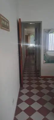 a hallway with a checkered floor in a room at Complejo La Paz in Villa Carlos Paz