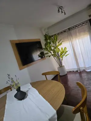 a dining room with a table and a tv at Vissia Cba in Cordoba