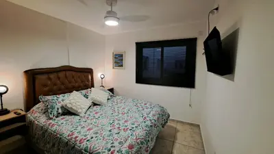 a bedroom with a bed and a window at Dpto a estrenar Asador Pileta Cochera propia Terraza privada con vista a sierras Seguridad 24 hs Av Colón Alberdi Ubicación estratégica H Clínicas Kempes Shopping Carlos Paz in Cordoba
