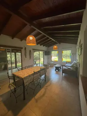 a living room with a wooden table and chairs at Casa terracota in Villa General Belgrano