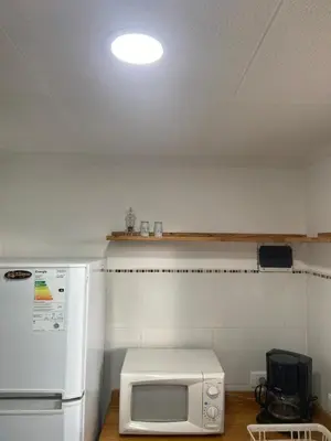 a kitchen with a white refrigerator and a microwave at Casa terracota in Villa General Belgrano