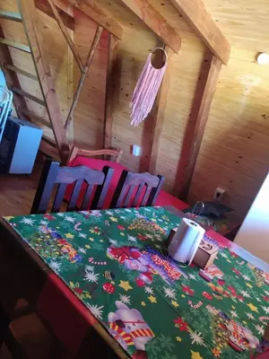 a table with two chairs and a table cloth with flowers at La Soñada in Santa Rosa de Calamuchita
