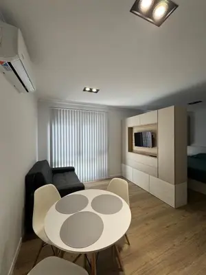 a small living room with a table and chairs at Apart Miralejos 17 villa carlos Paz in Cordoba