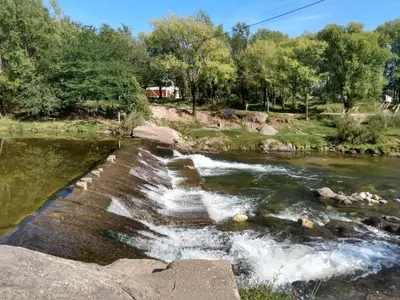 a river with rapids on the side of it at Paprikas in Villa Ciudad Parque