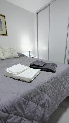 a bed with blankets and pillows on top of it at Patio Olmos a pasos in Cordoba